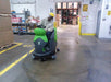 CT160 Ride On Floor Scrubber Cleaning a Floor in a Warehouse