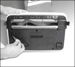 Removing the replacement belt from underneath the vacuum. Removing the replacement belt from underneath the vacuum.