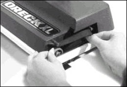 Removing the belt from the pulley on the brush roll. Removing the belt from the pulley on the brush roll.